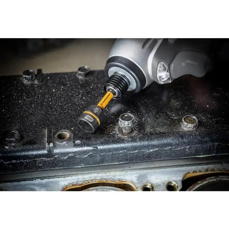 A GEARWRENCH Bolt Biter nut extractor driver, model 86170, is shown connected to an impact driver and positioned over a rusted bolt on a dark metal surface.