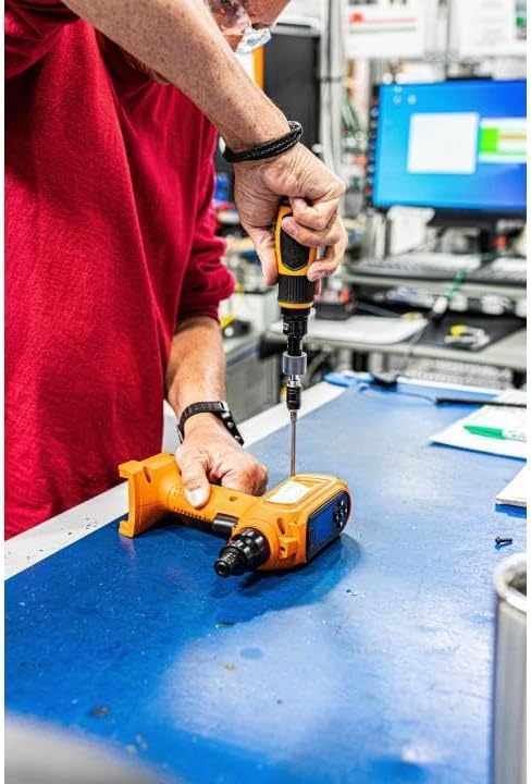 A professional technician using the Gearwrench 89620 torque screwdriver to perform precise assembly work on an electronic component at a laboratory workbench, emphasizing the tool's 10-50 in/lb accuracy.