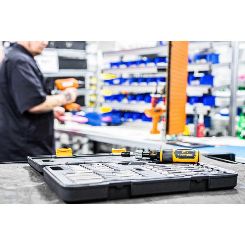 The Gearwrench 89620 20-piece torque screwdriver set resting on a industrial workstation in an assembly plant, highlighting the organized layout of the nut drivers and screwdriver bits in the storage case.