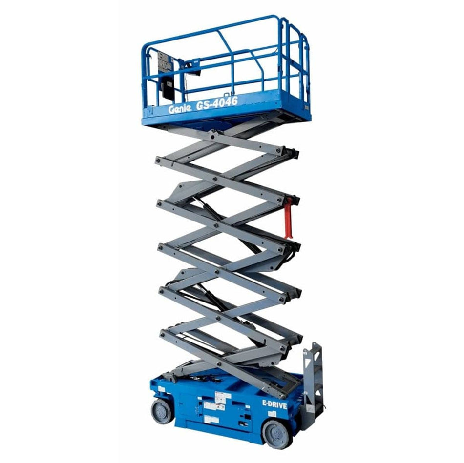 Genie GS-4046 scissor lift shown in full vertical extension with crisscrossing metal arms and guardrail platform. The electric-powered lift is labeled “E-DRIVE” and designed for safe elevation in commercial or industrial settings.