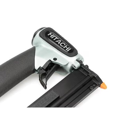 A high-angle close-up studio shot of the silver and black Hitachi NP35A, focusing on the trigger and the Hitachi logo on top.