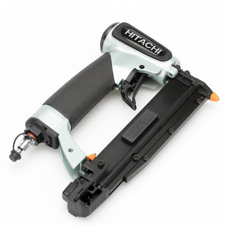 A high-angle, three-quarter studio shot of the silver and black Hitachi NP35A 23-gauge pin nailer.