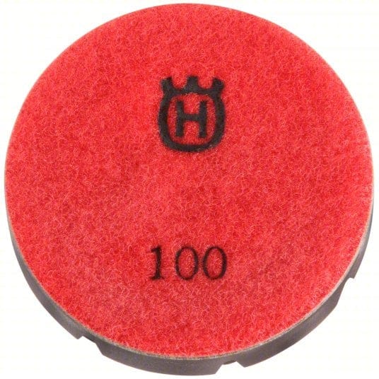 Red Husqvarna 3" polishing pad with felt-textured surface and black backing labeled “100” and crowned “H” logo; used for concrete finishing