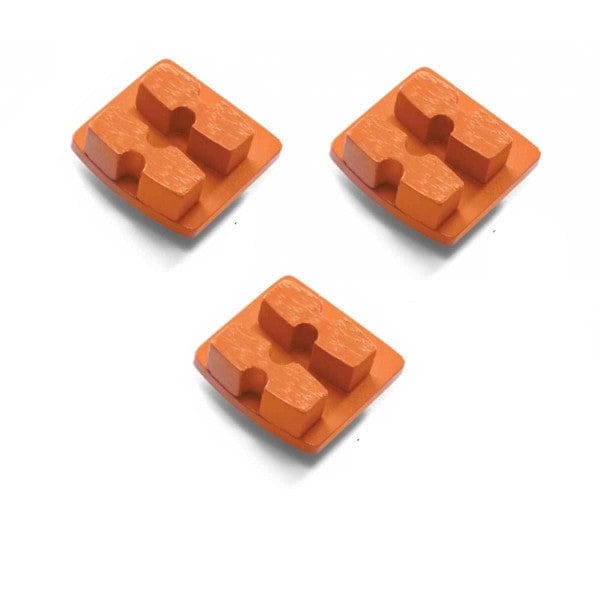 Three orange Husqvarna G1414D diamond grinding segments with rectangular bases and dual raised pads; designed for hard concrete surface prep.