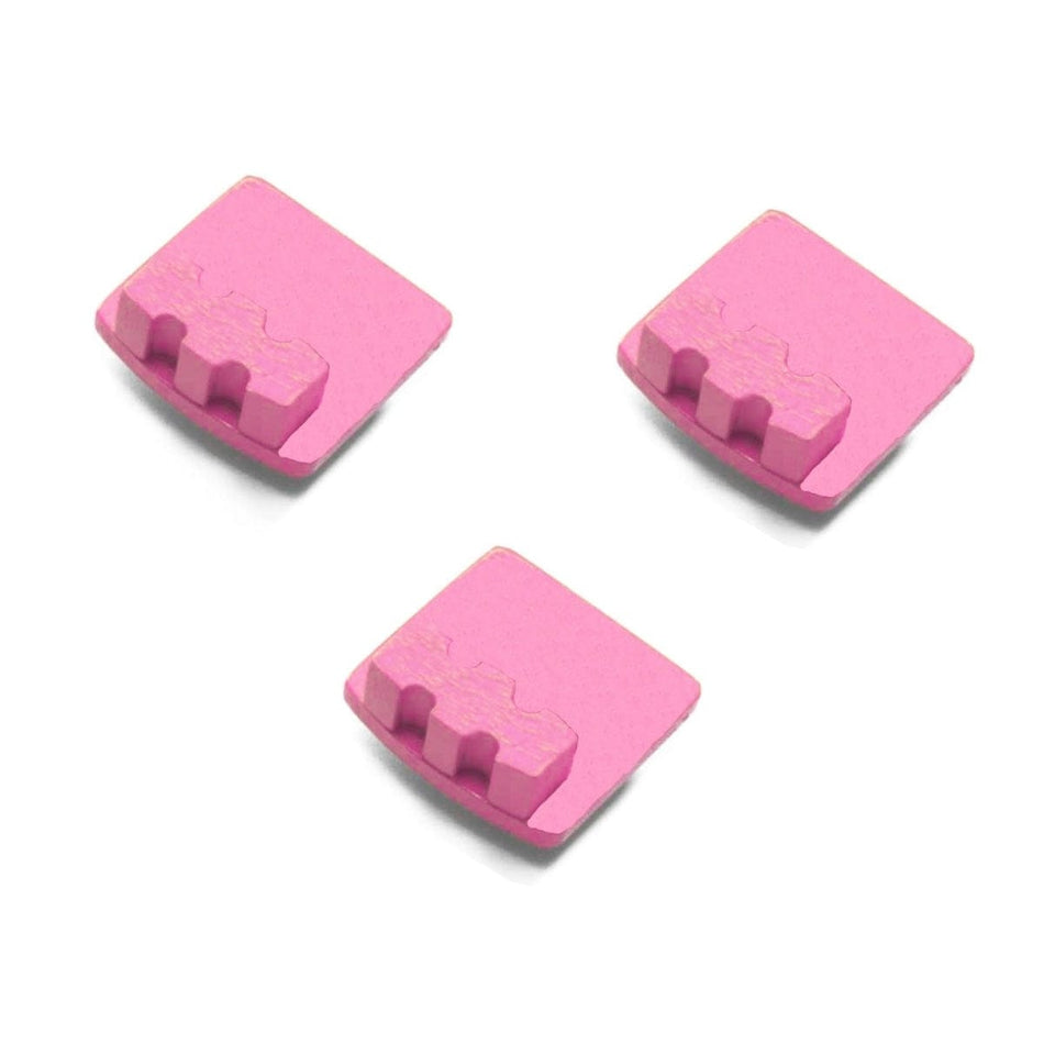 Three pink Husqvarna medium bond diamond grinding segments with raised terrain-like ridges; designed for epoxy, glue, and concrete removal.
