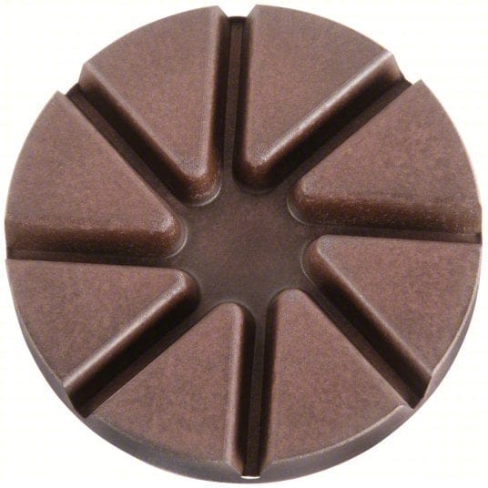 Segmented copper resin matrix face on a Husqvarna 100-grit pad engineered to remove metal scratches during concrete surface prep.