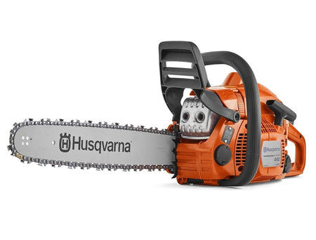 Angled view of Husqvarna 440 chainsaw featuring orange casing, black handle, silver guide bar with chain, and visible model number and X-Torq branding on engine housing.