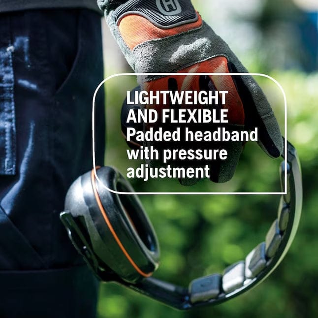 A close-up photo of a gloved hand holding the Husqvarna hearing protectors, highlighting the lightweight and flexible padded headband with pressure adjustment.
