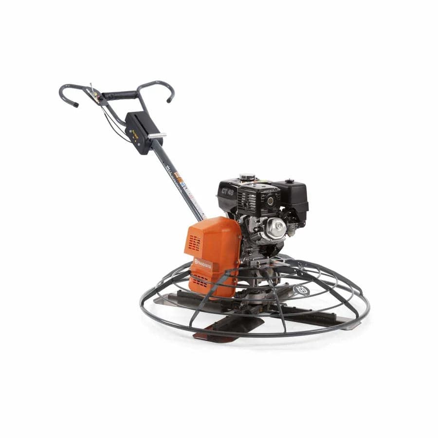 A high-angle view of the Husqvarna CT 48 power trowel showing the integrated safety stop mechanism on the Pro-Handle and the heavy-duty four-blade finishing system.