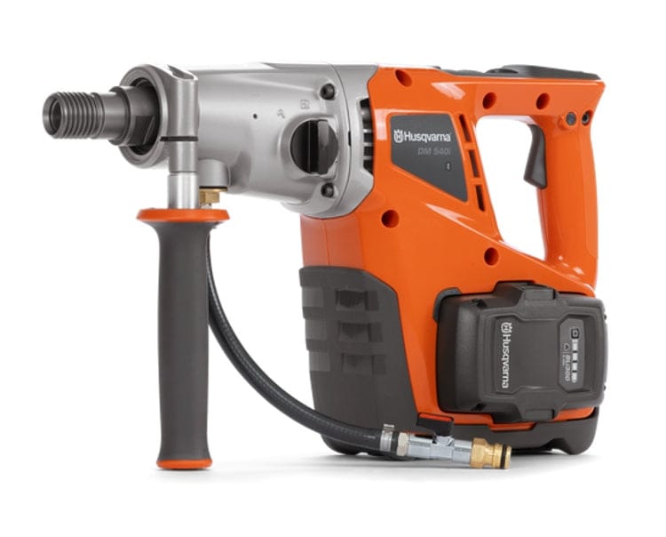 A studio product photograph of the Husqvarna DM 540i Battery Powered Core Drill Motor showcasing its ergonomic orange design, silver gearbox, and cordless battery operation for professional wet and dry coring.