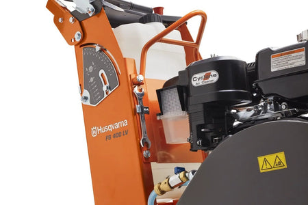 A close-up of the side panel of the saw, showing the cutting depth gauge, the large water tank, the Cyclone Air Cleaner, and a wrench secured to the frame.