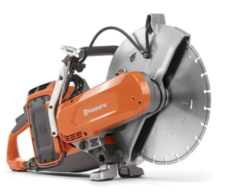 A side profile of the Husqvarna K1 PACE battery-powered cut-off saw featuring an orange motor housing, a silver 14-inch blade guard, and a diamond segment blade.