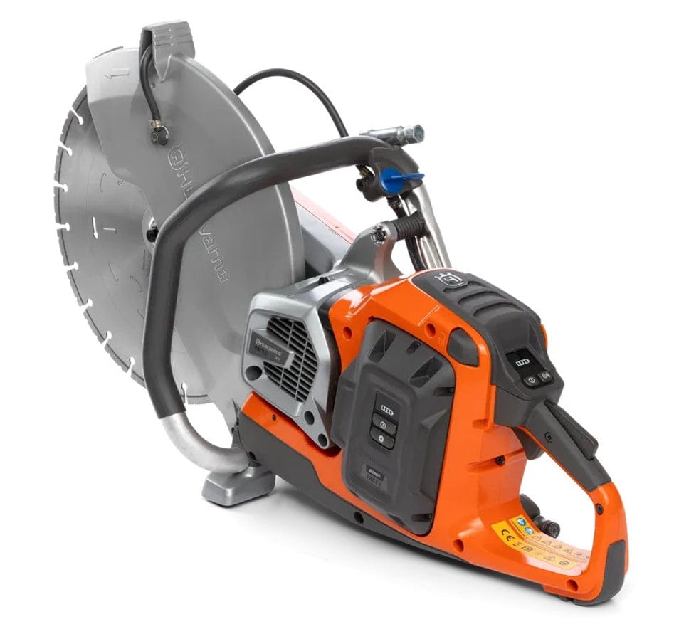 Top-down perspective of the Husqvarna K1 PACE saw highlighting the wrap-around front handle, blade guard assembly, and the orange and gray motor housing.