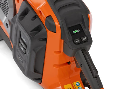Close-up view of the digital interface on the Husqvarna K1 PACE saw showing the battery level indicator and the power and connectivity control buttons.
