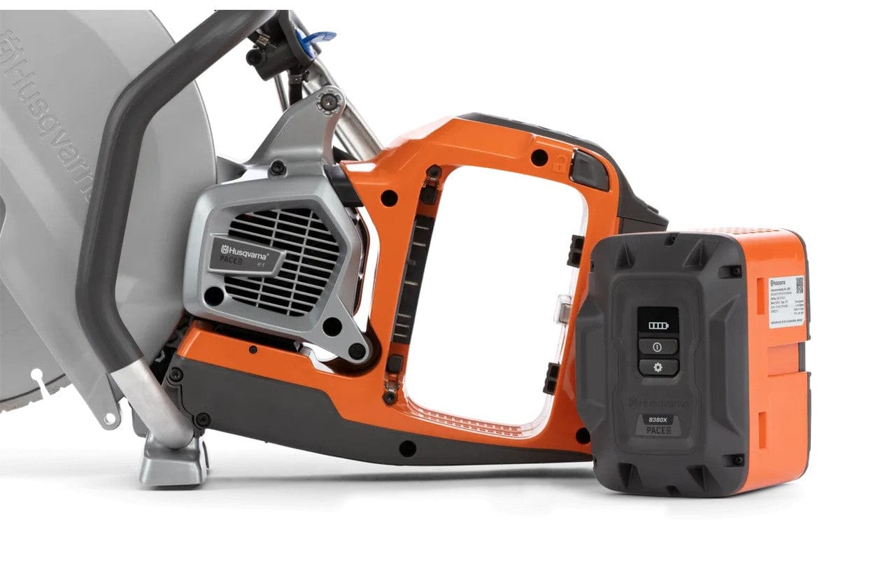 Close-up side view of the Husqvarna K1 PACE battery compartment with a B380X PACE battery positioned next to the saw for installation.