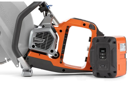 Close-up side view of the Husqvarna K1 PACE battery compartment with a B380X PACE battery positioned next to the saw for installation.