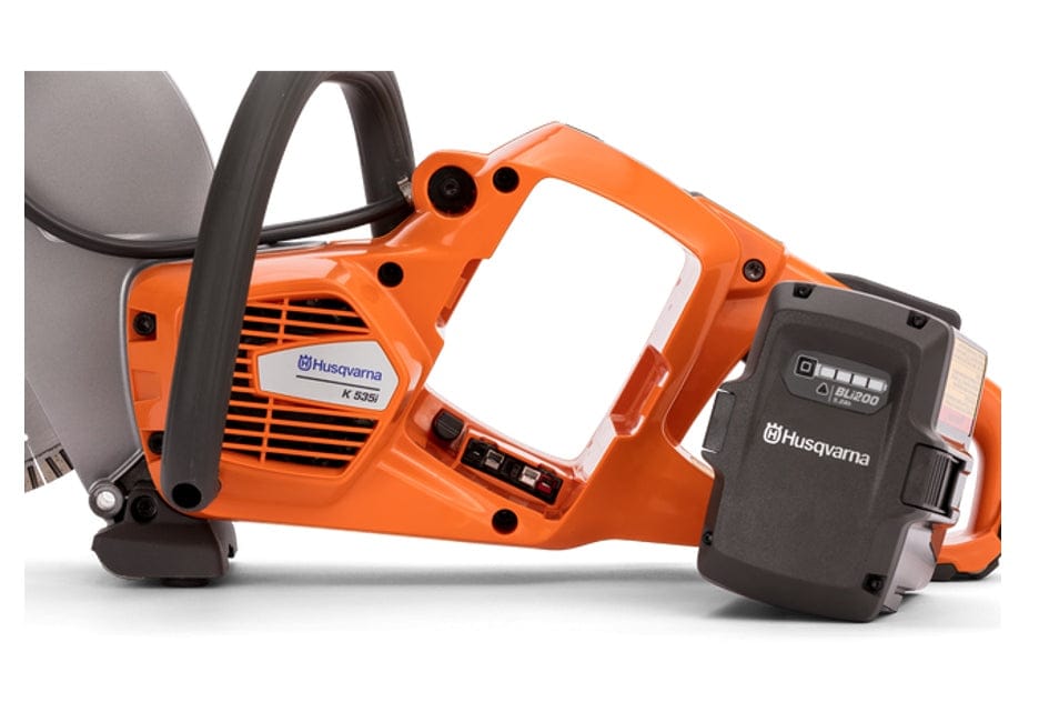 Close-up view of the Husqvarna K535i saw body, showing the side-feed battery placement. A compatible Husqvarna BLi200 battery is partially inserted into the slot.