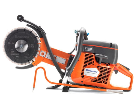 A side-profile studio photograph of the Husqvarna K760 Cut-n-Break II saw showing the orange engine housing, dual blade assembly, and the integrated ruler on the blade arm.