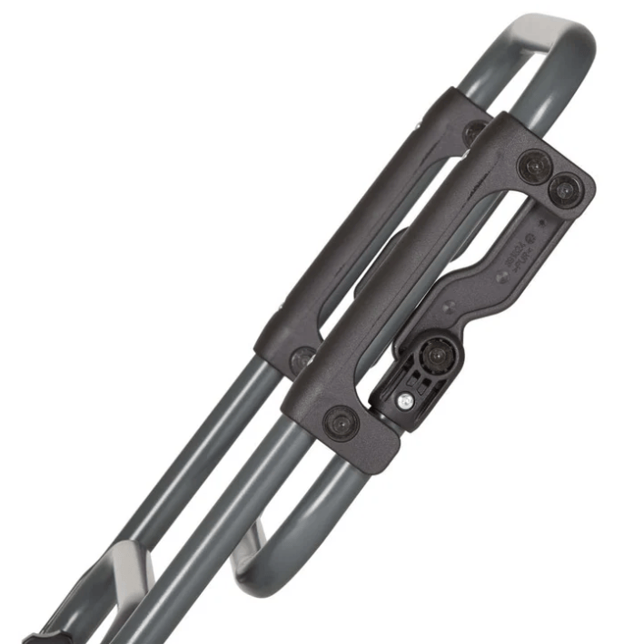 Close-up of a telescoping suitcase handle mechanism with dual metal rods and a plastic grip housing.