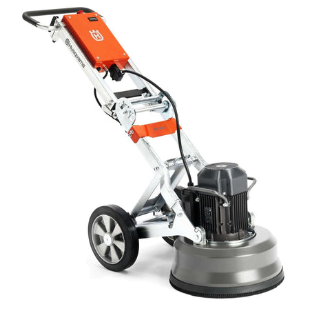Three-quarter studio view of the Husqvarna PG 450 planetary floor grinder, showcasing its robust 18-inch grinding head, adjustable metal frame, and large transport wheels for industrial concrete polishing.