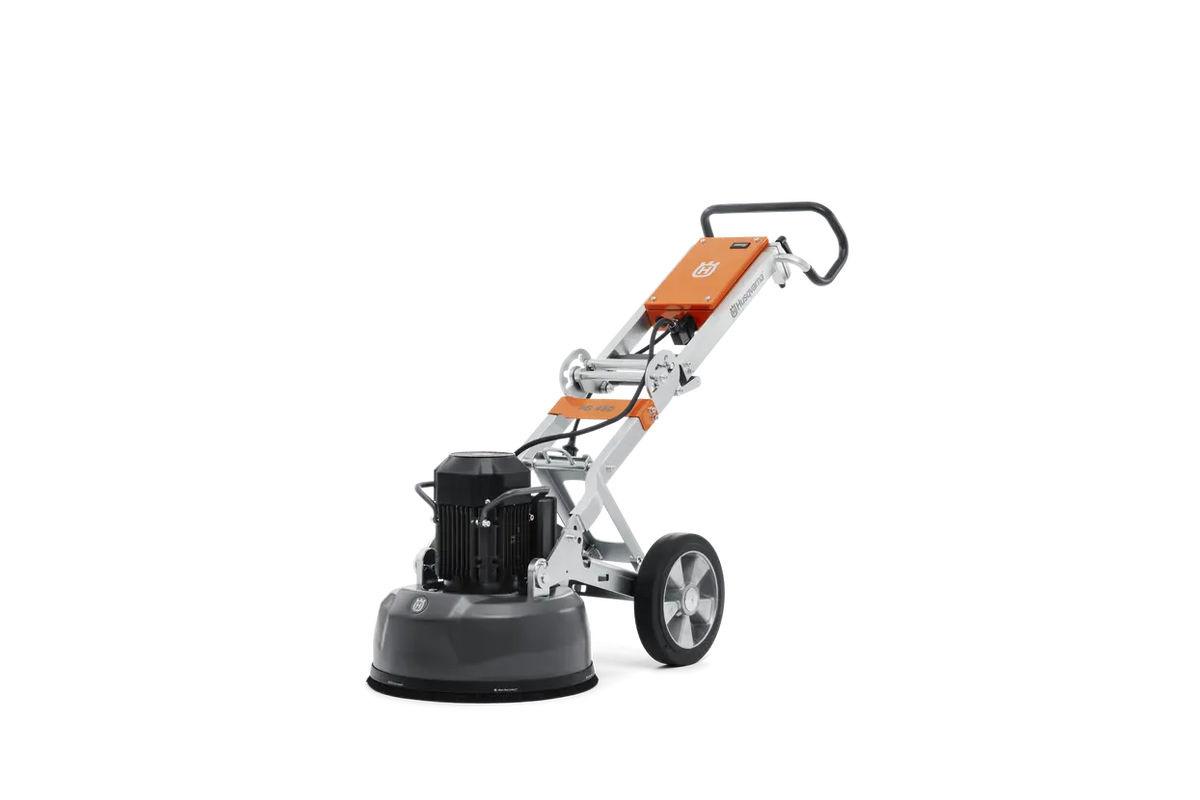Rear three-quarter view of the Husqvarna PG 450 planetary floor grinder, showcasing the brush skirt and floating cover designed for effective dust management during concrete grinding.