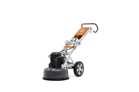 Rear three-quarter view of the Husqvarna PG 450 planetary floor grinder, showcasing the brush skirt and floating cover designed for effective dust management during concrete grinding.