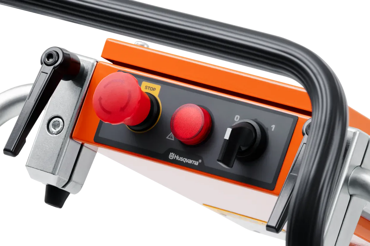 Close-up of the Husqvarna PG 450 control panel, featuring the emergency stop button, power indicator light, and simplified on-off switch for intuitive machine operation.