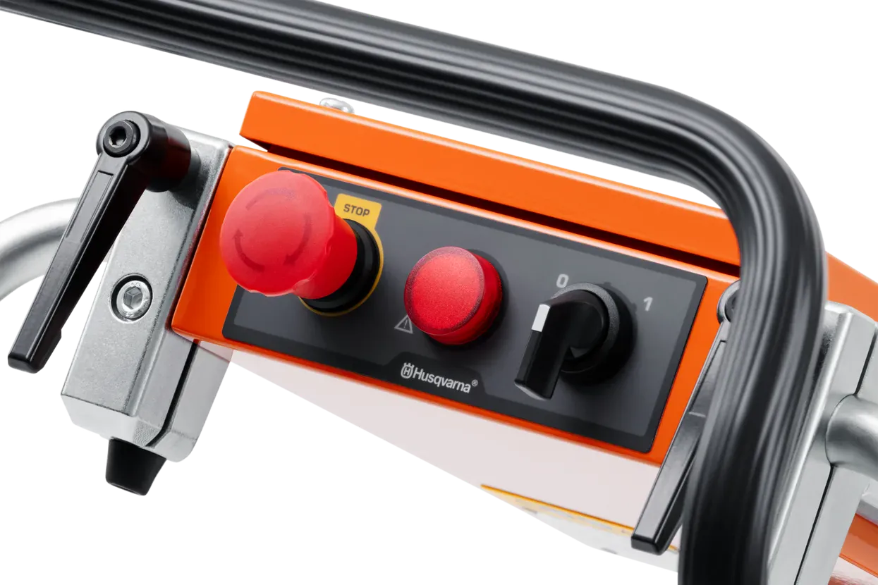Close-up of the Husqvarna PG 450 control panel, featuring the emergency stop button, power indicator light, and simplified on-off switch for intuitive machine operation.