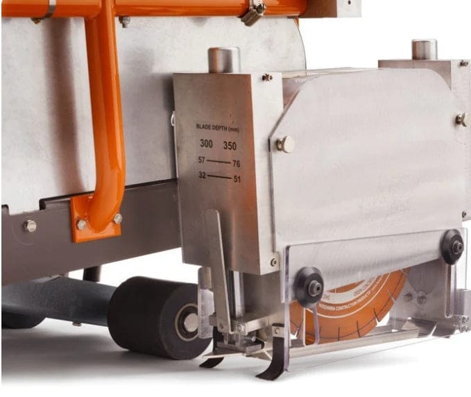 A close-up detail shot of the enclosed blade guard on the Husqvarna Soff-Cut 4000, showing a 13.5-inch orange early-entry blade and a technical decal listing blade depth settings in millimeters.