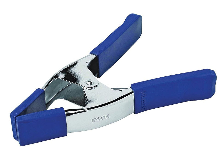 Angled studio view of the IRWIN 3-inch spring clamp, showcasing the polished steel body, blue vinyl handles, and non-marring blue soft grip jaw pads