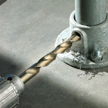 An IVY Classic cobalt drill bit in action, drilling a hole into a galvanized metal post flange, creating metal shavings.