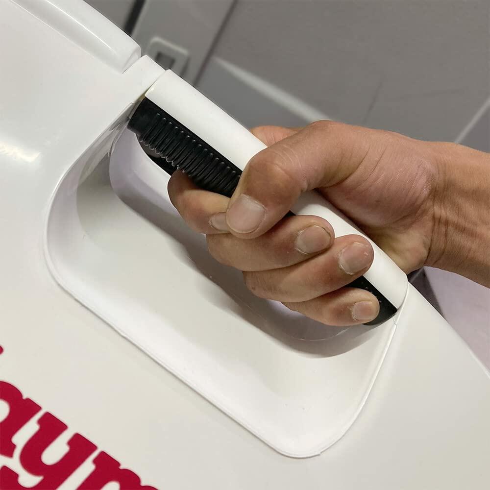 Close-up of a person gripping the black and white handle of an Igloo Playmate Elite Ultra cooler. Partial red “Playmate” logo visible on lid, highlighting ergonomic design and portability.
