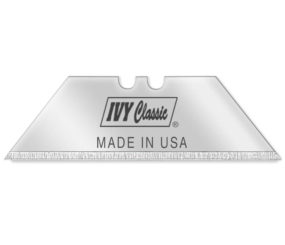 Close-up of an Ivy Classic heavy-duty high-carbon steel utility knife blade featuring a precision-honed edge, two standard mounting notches, and Made in USA engraving.
