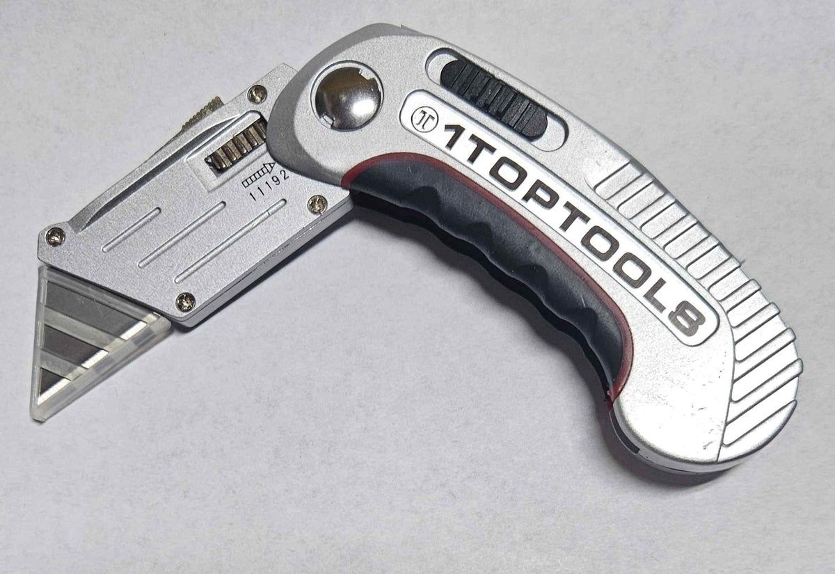 Studio shot of the 1 Top Tools folding utility knife model 11192 featuring a silver all-metal body with a black rubberized grip and a clear safety guard over the blade tip.