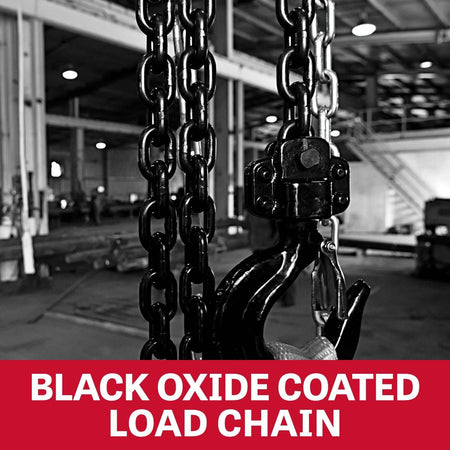 Close-up view of the black oxide coated grade 80 load chain hanging vertically in an industrial setting.