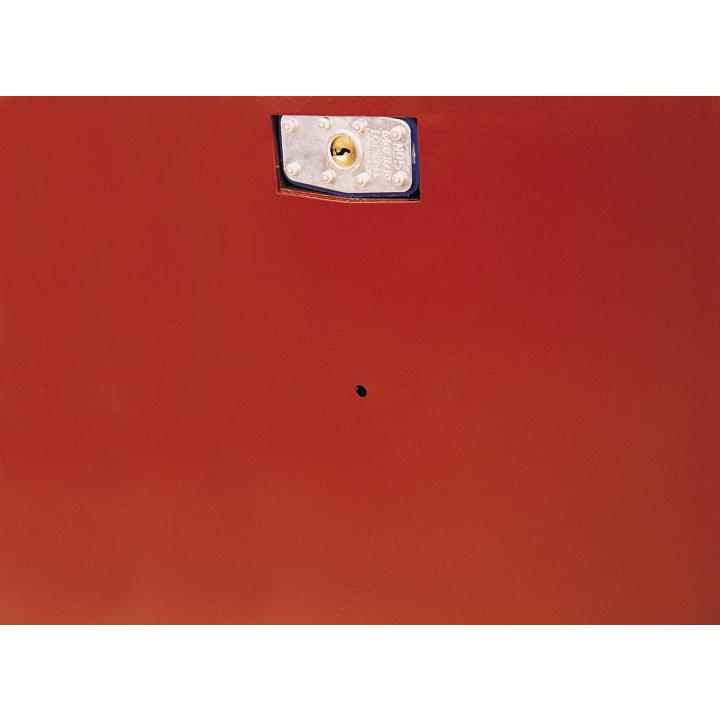 Close-up of a metallic lock plate with keyhole mounted on a red metal surface. The lock is secured with four screws and designed to protect access to the Jobox piano storage chest