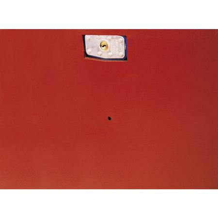 Close-up of a metallic lock plate with keyhole mounted on a red metal surface. The lock is secured with four screws and designed to protect access to the Jobox piano storage chest