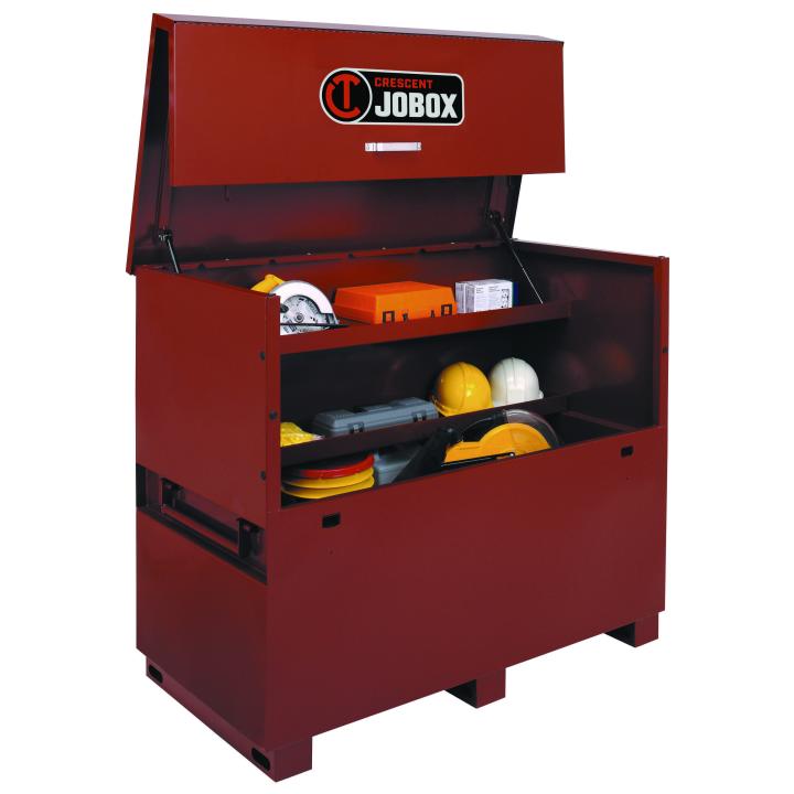 Open Jobox storage chest containing safety gear including hard hats, earmuffs, safety vests, a first aid kit, and flashlight. The chest is designed for secure and organized jobsite equipment storage.