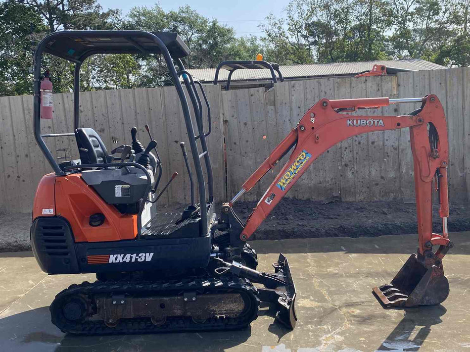 Kubota KX41-3V Compact Mini Excavator on concrete near a fence