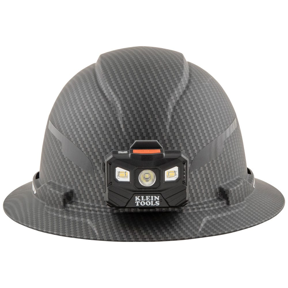 Front view of Klein Tools KARBN full brim hard hat with mounted 400-lumen LED headlamp for hands-free illumination.