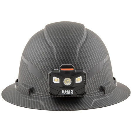 Front view of Klein Tools KARBN full brim hard hat with mounted 400-lumen LED headlamp for hands-free illumination.