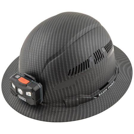Klein Tools 60347 Class C vented full brim hard hat in KARBN pattern featuring adjustable side vents and a mounted LED headlamp.