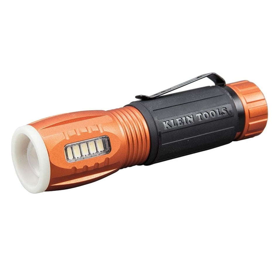 A three-quarter studio profile of the Klein 56028 LED flashlight, showing the main light, side work light, and pocket clip.