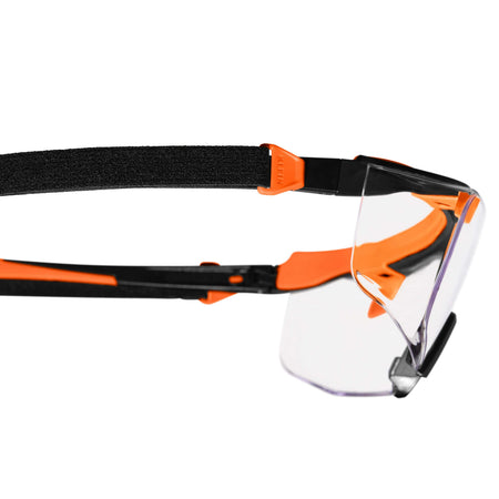 Close-up side profile of the eyewear highlighting the integrated attachment point for the removable strap on the orange and black nylon stems.