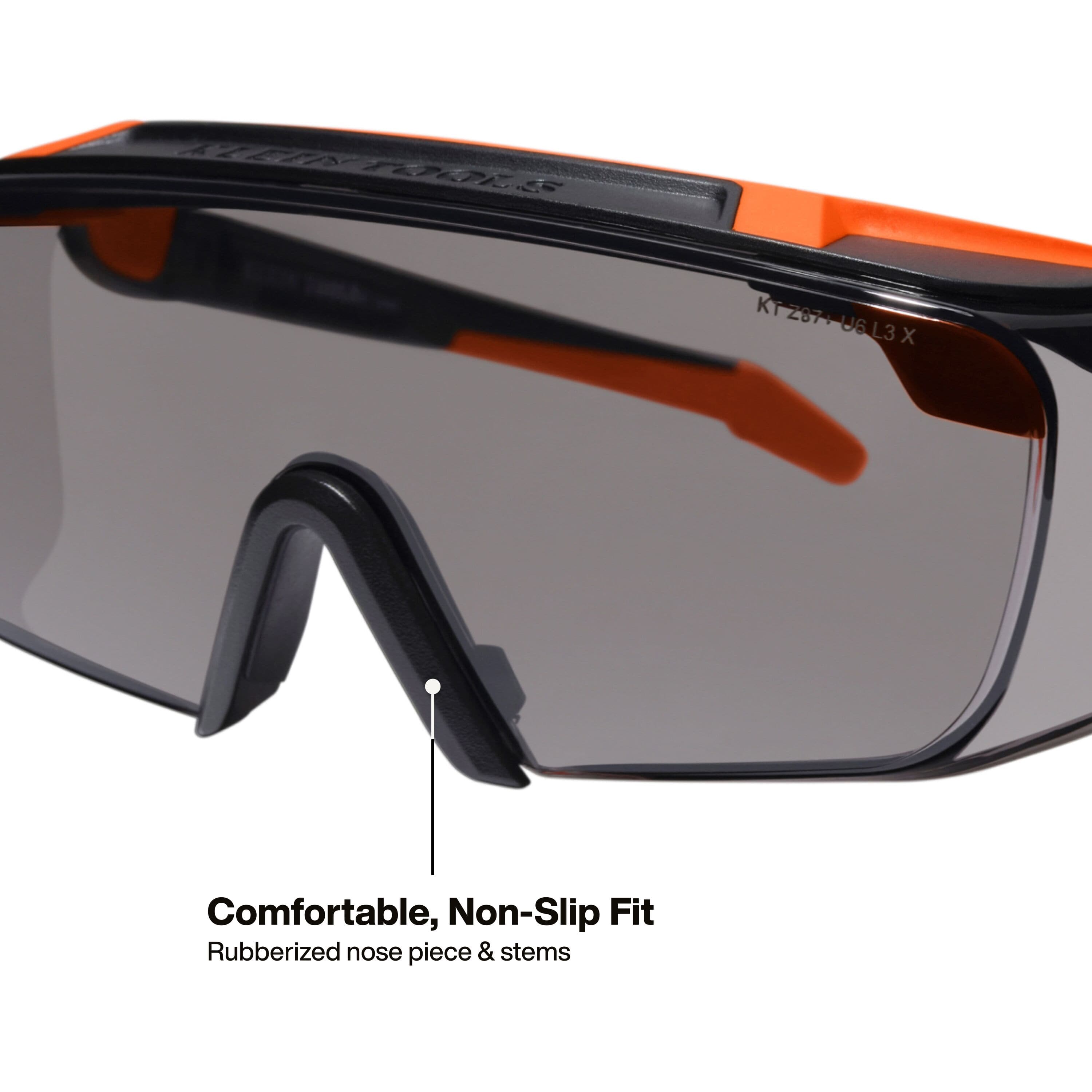 Macro perspective detail of the interior of the safety eyewear showing the comfortable rubberized nose piece and stems designed for a secure, non-slip fit during high-activity tasks.