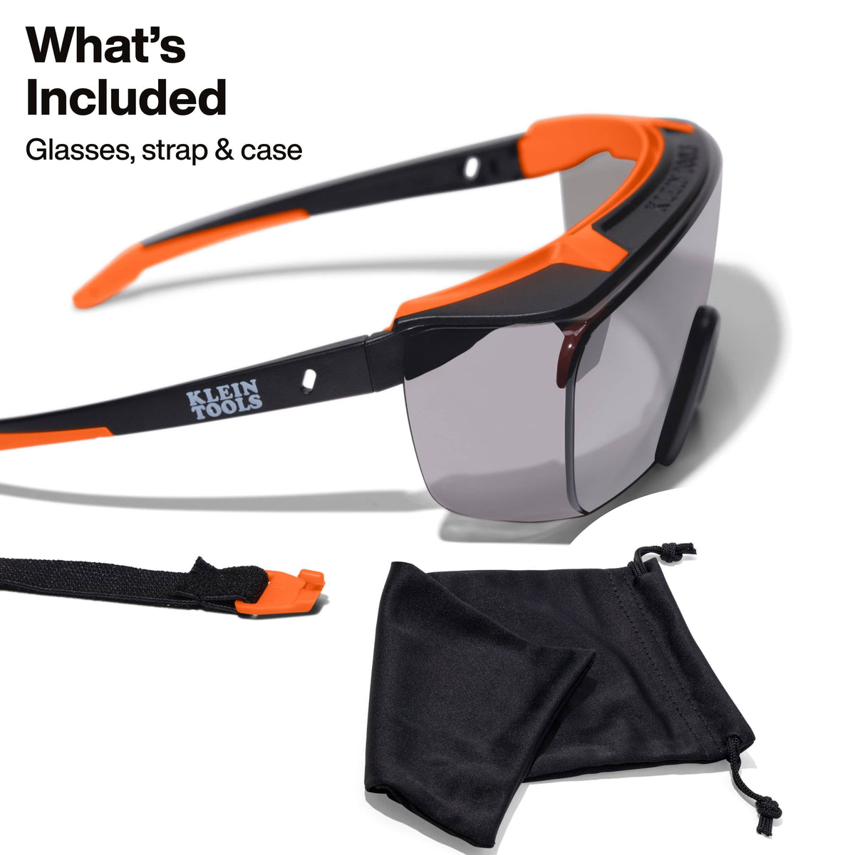 Product kit overview showing the included components: the gray shaded high-impact safety glasses, a removable security strap, and a black microfiber cleaning and storage pouch.