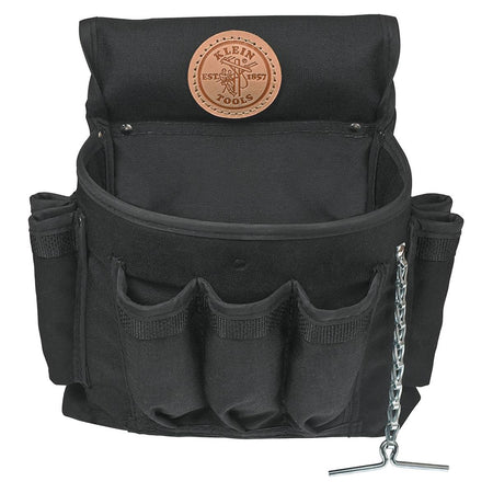 Close-up of the Klein Tools 12-pocket tool pouch made from durable black Cordura fabric, featuring a leather logo patch and a metal chain tape thong for organized gear storage.