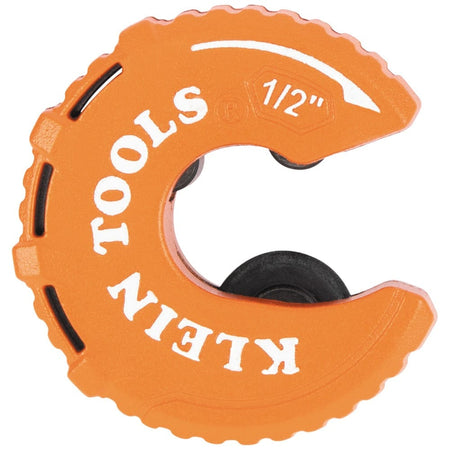 A direct profile view of the orange Klein Tools 50055 C-style copper tubing cutter against a white background. The 1/2-inch size marking and rotation arrow are clearly visible on the high-visibility body, showcasing the compact circular design used for plumbing in confined spaces.