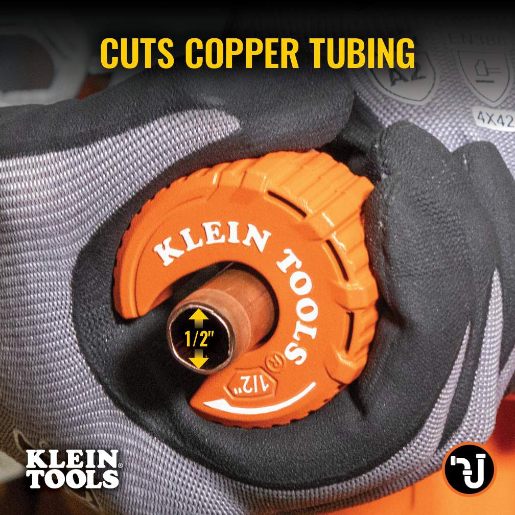 Close-up action shot of a hand in a work glove using the Klein Tools C-style cutter to slice through copper tubing. Large yellow text reads Cuts Copper Tubing, highlighting the tool's primary function for 1/2 inch plumbing lines.