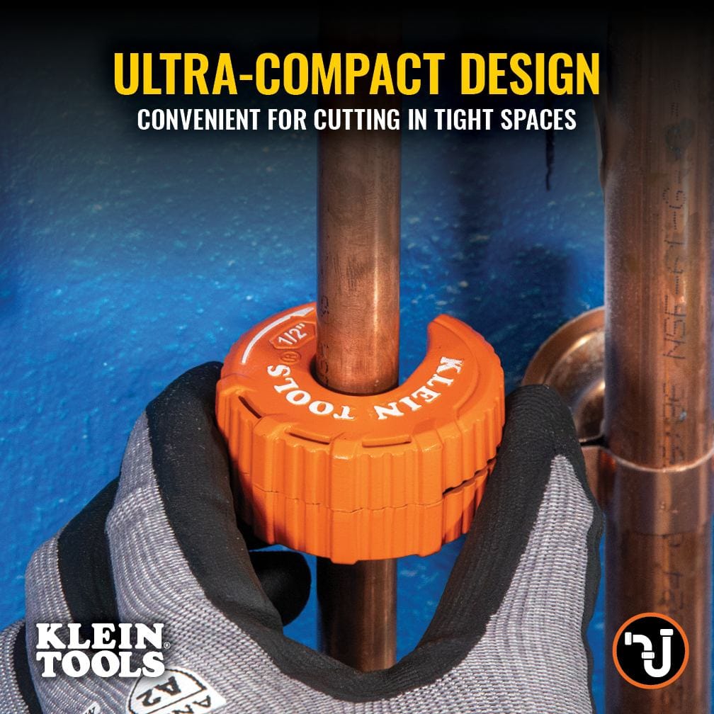 Demonstration of the Klein Tools 50055 in a confined plumbing environment with the text Ultra-Compact Design. The image shows the tool being rotated on a vertical copper pipe in a tight space against a blue wall, proving its effectiveness where traditional cutters cannot fit.